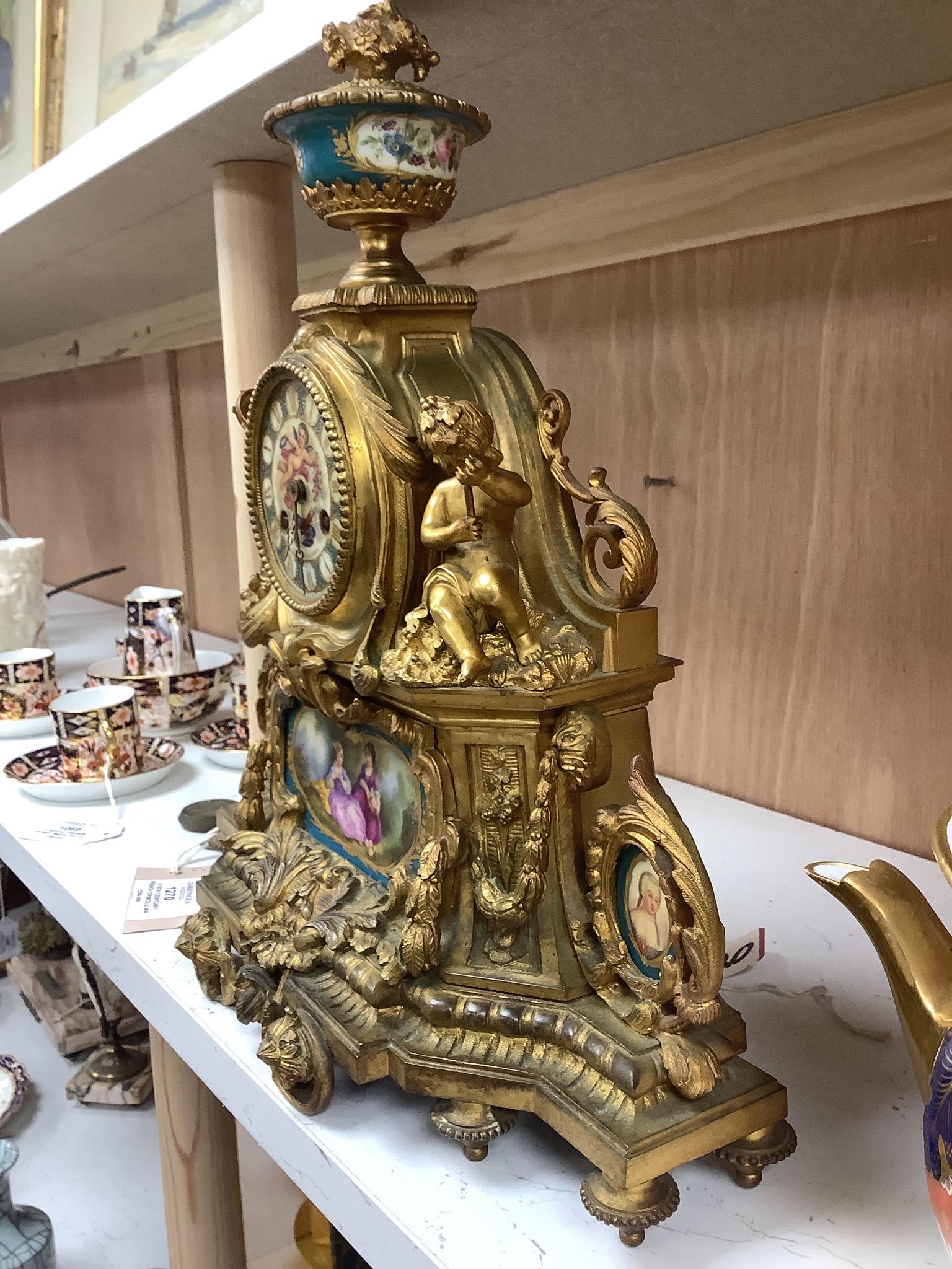 A 19th century French ormolu and Sevres style porcelain mounted mantel clock, with key and pendulum, 35 cm high